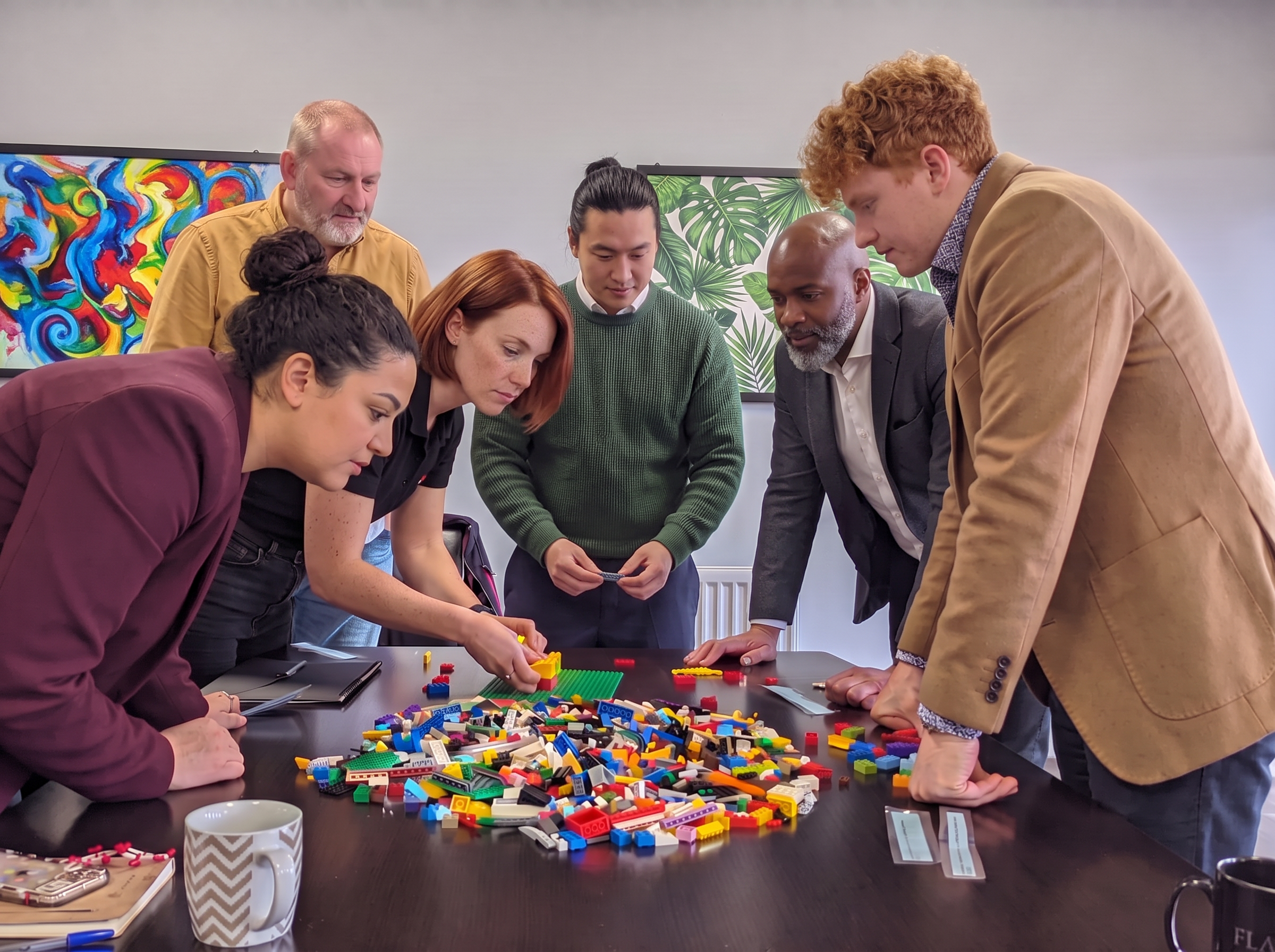 A team building ideas together with colourful bricks around a table